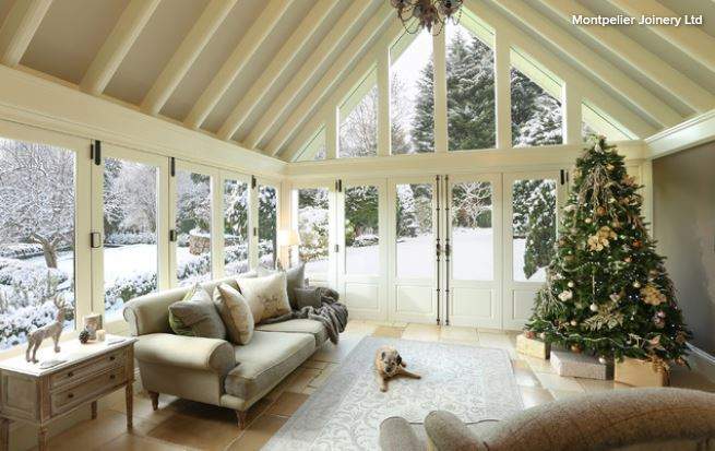 fully decorated christmas tree in sun room