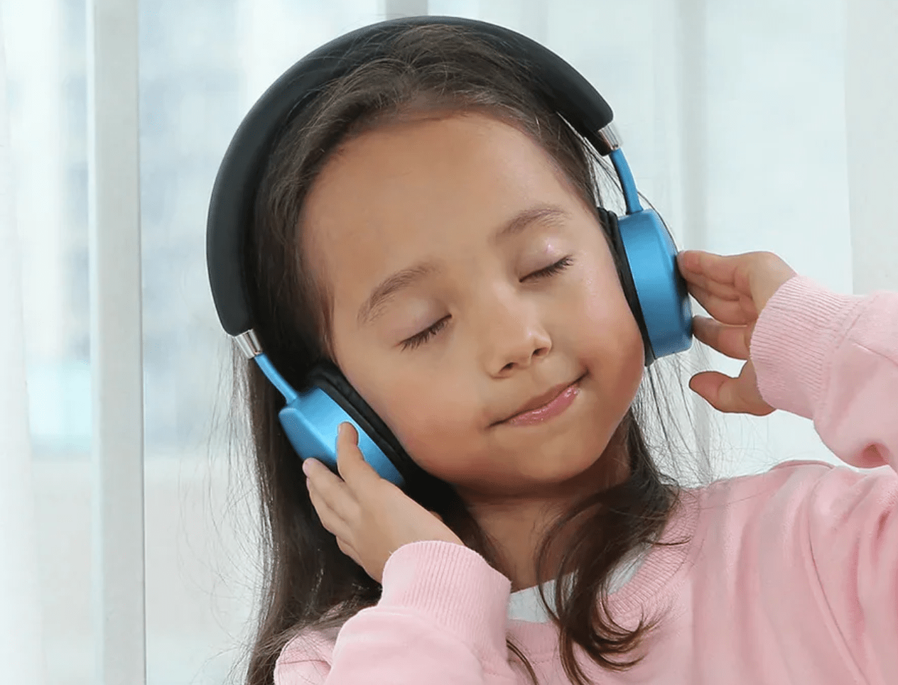 Little girl listening to headphones